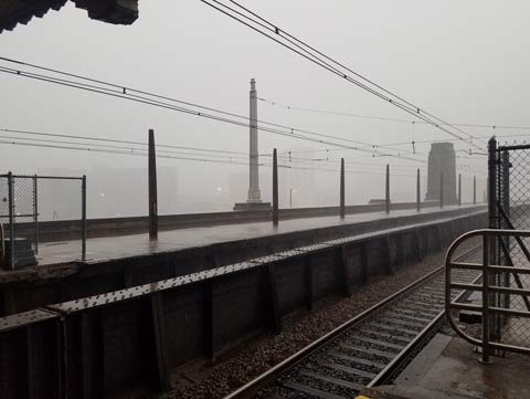 Photo looking out of 30th Street train station, the tracks heading into mist