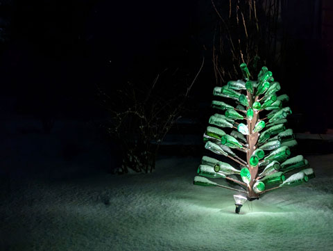 Tree made out of a 4x4, rebar, and green bottles; Lit from below with a spotlight
