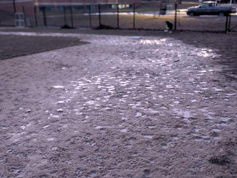 Muddy infield, from behind second base looking toward third